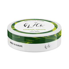 Flat-angle view of Glick Citrine Grape Slim Nicotine Pouches, Light Series. The can features a sleek white base with green and yellow marble-like accents around the edge. The top highlights the 'Citrine Grape' flavour in green text, with the Glick logo prominently displayed above. This light nicotine pouch includes three mild strength indicators (4mg nicotine) and a 'Made in Europe' label on the side for quality assurance.