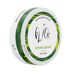 Side angle view of Glick Citrine Grape Slim Nicotine Pouches, Light Series. The can displays a white base with dynamic green and yellow marble accents along the sides, complementing the 'Citrine Grape' flavour. The Glick logo and 'Slim Nicotine Pouches' branding are prominently featured. The light nicotine strength of 4mg is highlighted with three light intensity markers, appealing to users seeking a subtle nicotine experience. The design includes a 'Made in Europe' label, ensuring premium quality.