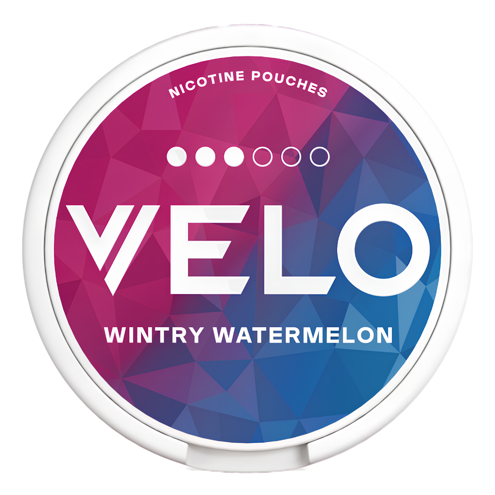 A round nicotine pouch can with a white plastic rim and a colorful geometric label. The label features a faceted polygon pattern transitioning from magenta-pink to purple and blue, with the brand name 'VELO' in large white letters and the flavor 'WINTRY WATERMELON' printed below.