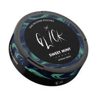 Angled top-down view of Glick Sweet Mint Slim Nicotine Pouches, Extreme Series. The black container highlights the 'Sweet Mint' flavour, featuring green and blue swirl patterns, the Glick logo, and strength markers for 10mg nicotine. The sleek design includes 'Made in Europe' branding on the side. Perfect for a refreshing and strong nicotine experience available in Australia and New Zealand.