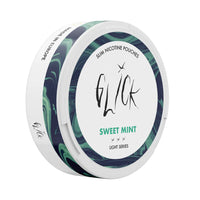 Side-angle view of Glick Sweet Mint Slim Nicotine Pouches, Light Series. This sleek white can features green and blue marble accents on the side, with the 'Sweet Mint' flavour highlighted in green text on the front. The can displays a 4mg nicotine strength with three light intensity markers, offering a mild and refreshing mint experience. Labelled 'Slim Nicotine Pouches' and 'Made in Europe,' it is tailored for light nicotine users in Australia and New Zealand.