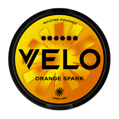 A round black container of Velo Orange Spark nicotine pouches by Tingling, featuring a vibrant orange and yellow sunburst design with bold black text.
